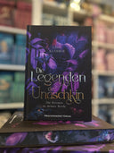 Das Bild zeigt das Buch "Die Legenden der Unaschkin - Die Dornen in deiner Seele" von vorn. Das Cover ist dabei direkt auf den Betrachter gerichtet; es zeigt einen violetten Dschungel, in dem sich diverse Tiere verbergen.
