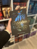 Das Bild zeigt das Buch "Die Legenden der Unaschkin - Sammelband" von vorn. Das Cover ist dabei direkt auf den Betrachter gerichtet; es zeigt einen blauen Dschungel, in dem sich diverse Tiere verbergen.