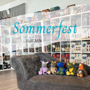 Auf dem Bild sieht man vier Plüschdrachen auf einem Sofa sitzen, das vor Bücherregalen steht. Darüber befindet sich der Schriftzug des Events samt Datum. 